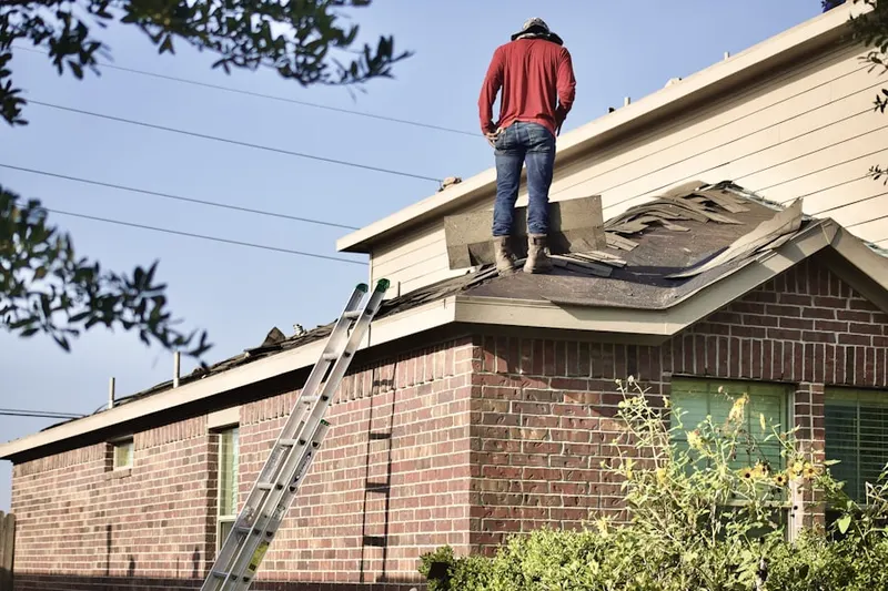 Professional roofer working on a residential roof in Zilker
